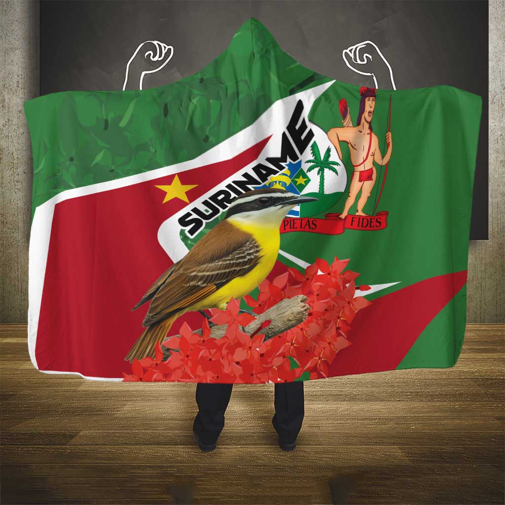Hooded blanket with green Suriname flag design, bird graphic, and small figure print