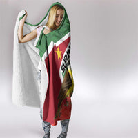 Hooded blanket with green hood, red flag panel, bird print, and white sherpa lining