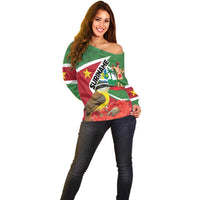 Women’s off-shoulder sweater, green with flag design, bird graphic, and off-shoulder neckline