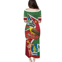 Off-shoulder long dress with short sleeves, green-red flag graphic print, back view.