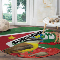 Round Suriname-themed area rug with large 'SURINAME' text, bird and palm on red/green