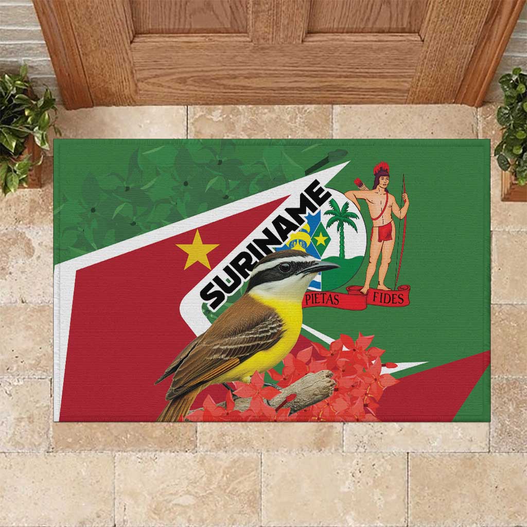 Green rubber doormat featuring Suriname logo, bird, dancer figure, red/white stripe