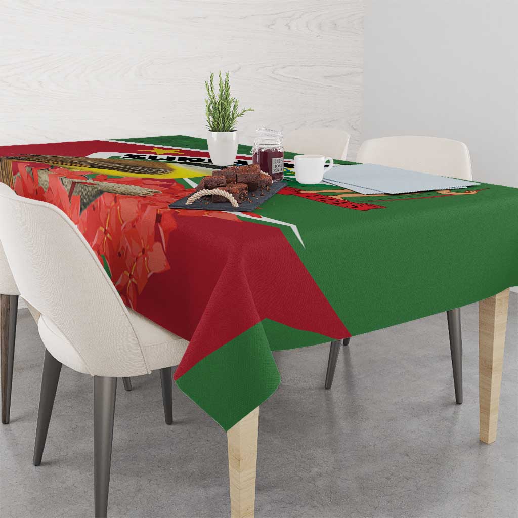 Suriname tablecloth with flag graphic, red floral leaves and green draped edge