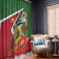 Green and red window curtain with bird, palm figure, and flag-style stripe pattern