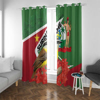 Green window curtains with grommets, featuring bird, palm figure, and red flower pattern