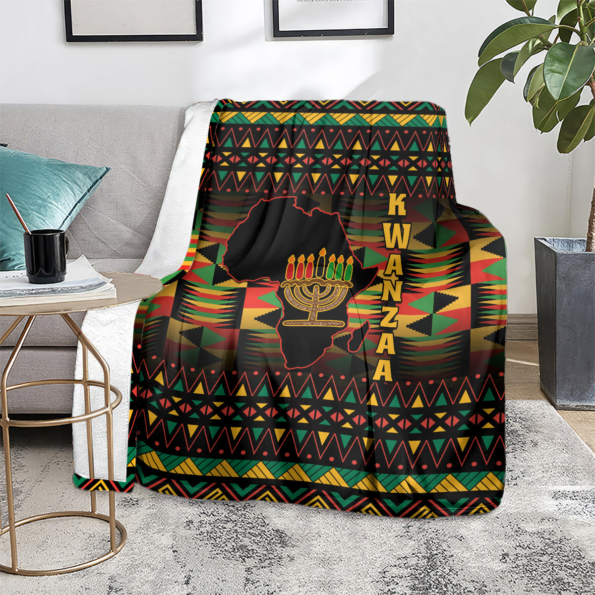 Kwanzaa throw blanket on floor, black geometric design with kinara candles and KWANZAA text
