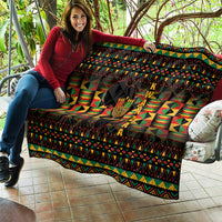 Kwanzaa festival quilt with kinara candle center, multicolor triangles, and patterned border