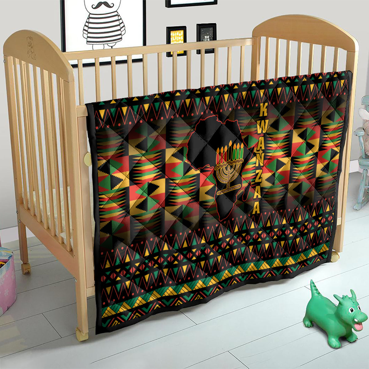 Kwanzaa festival quilt in crib with black geometric pattern and kinara candle graphic