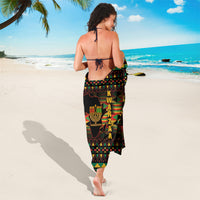 Black Kwanzaa sarong with vertical Kwanzaa text and kinara candles graphic