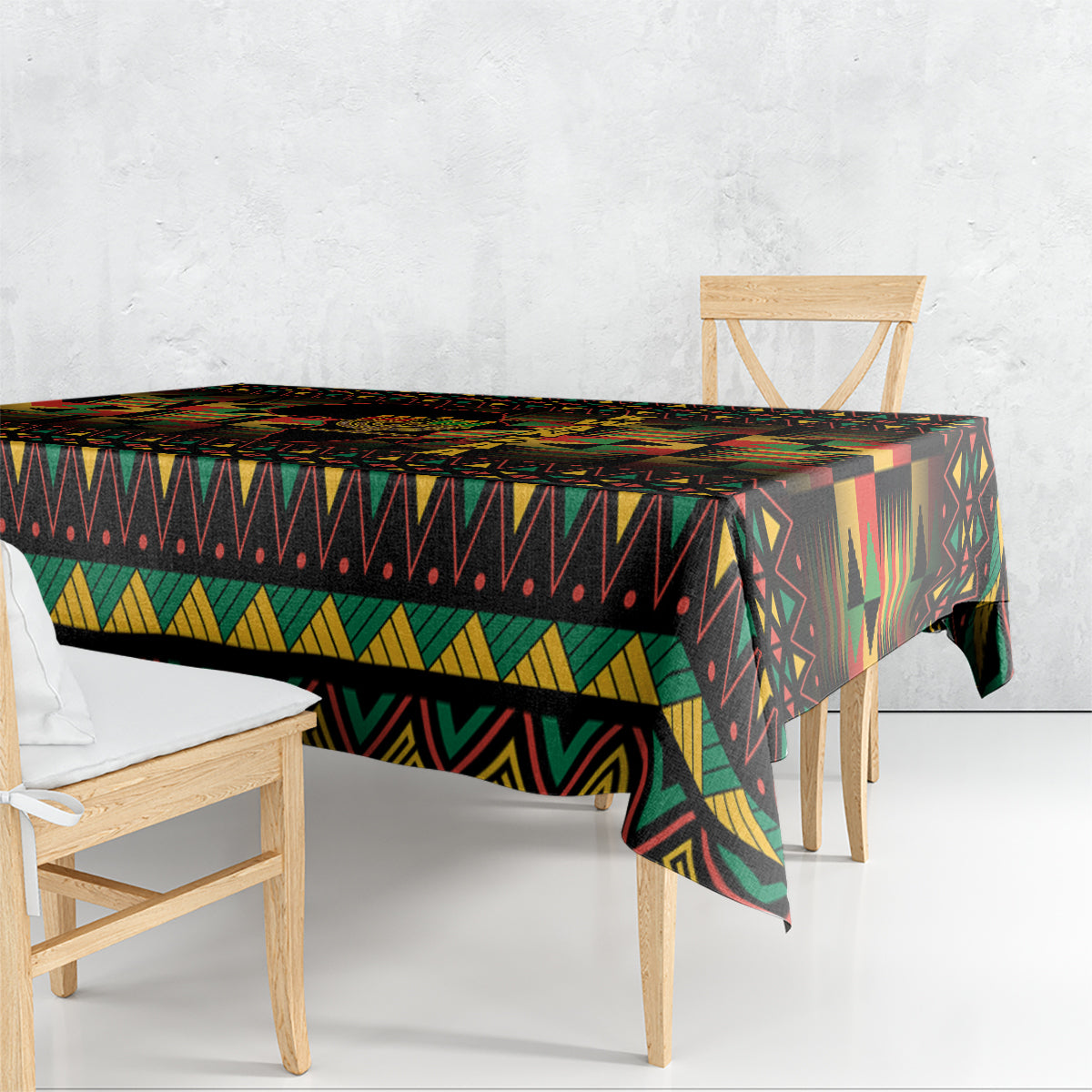 Kwanzaa festival tablecloth with bold geometric stripes, draped over table corner, black base.