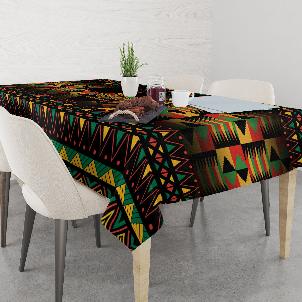 Kwanzaa festival tablecloth, black with multicolor geometric pattern, neatly spread on dining table.