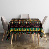 Kwanzaa festival tablecloth, black geometric bands and vibrant triangles, rectangular fit on table.