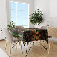 Kwanzaa festival tablecloth in multicolor African pattern on dining table, black base.