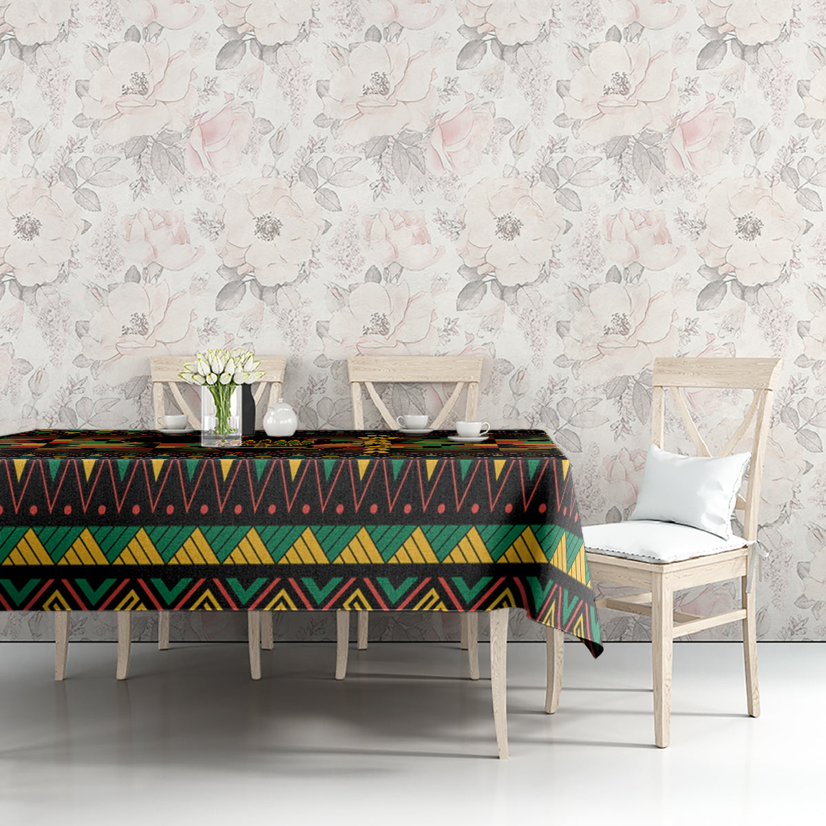 Kwanzaa festival tablecloth on dining table, black with multicolor geometric border and center band.