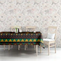 Kwanzaa festival tablecloth on dining table, black with multicolor geometric border and center band.