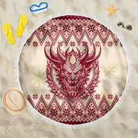 Round beach blanket with red Krampus head graphic, winter diamond border, white fringe edge