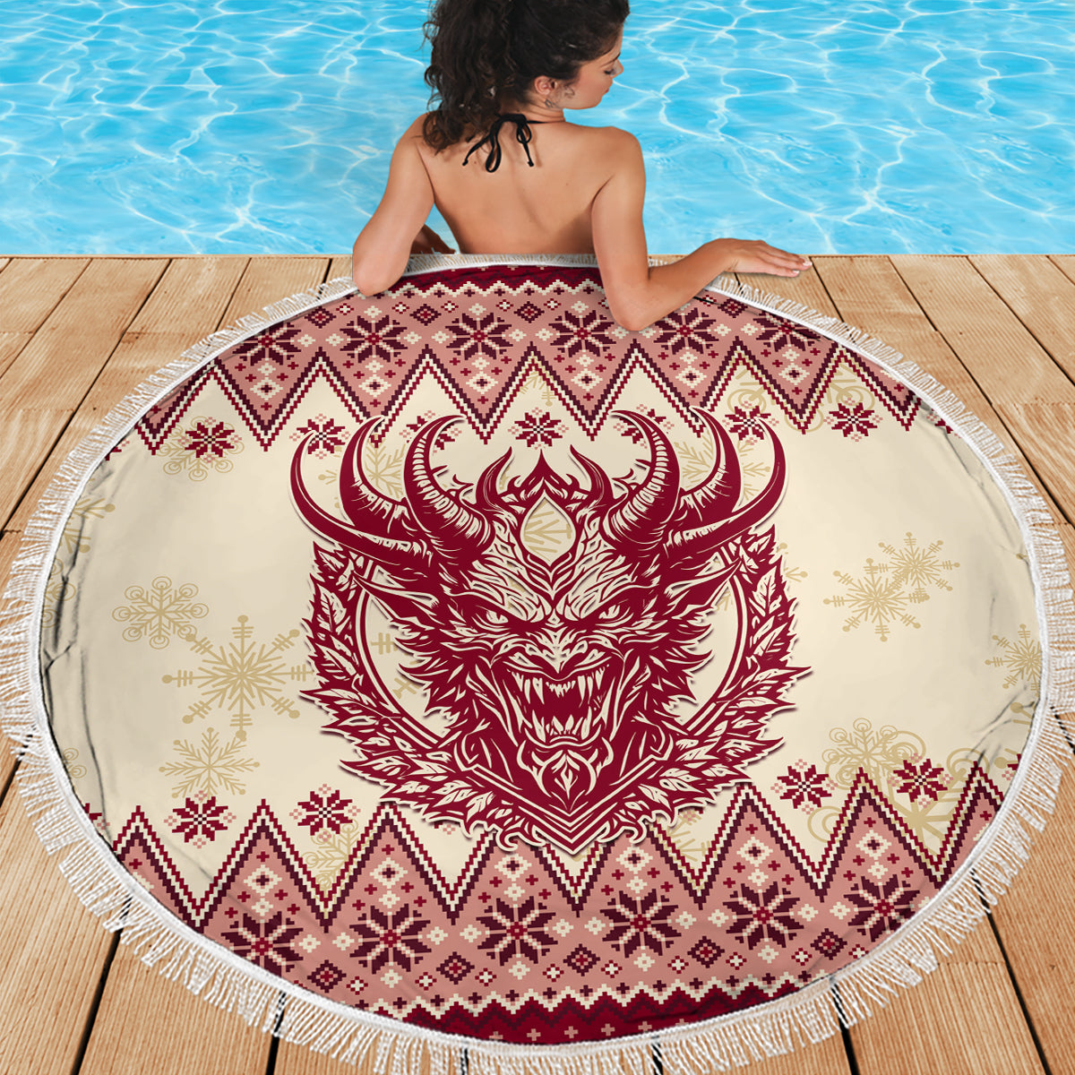 Round beach blanket with red Krampus face centerpiece, winter motifs, white fringe border