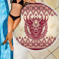 Round beach blanket in pool setting: red Krampus head print, diamond and snowflake pattern, fringe