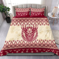 Red and cream bedding set with Krampus devil face center and matching patterned pillowcases
