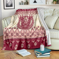 Red and cream Krampus Christmas blanket over a sofa with snowflake and diamond borders