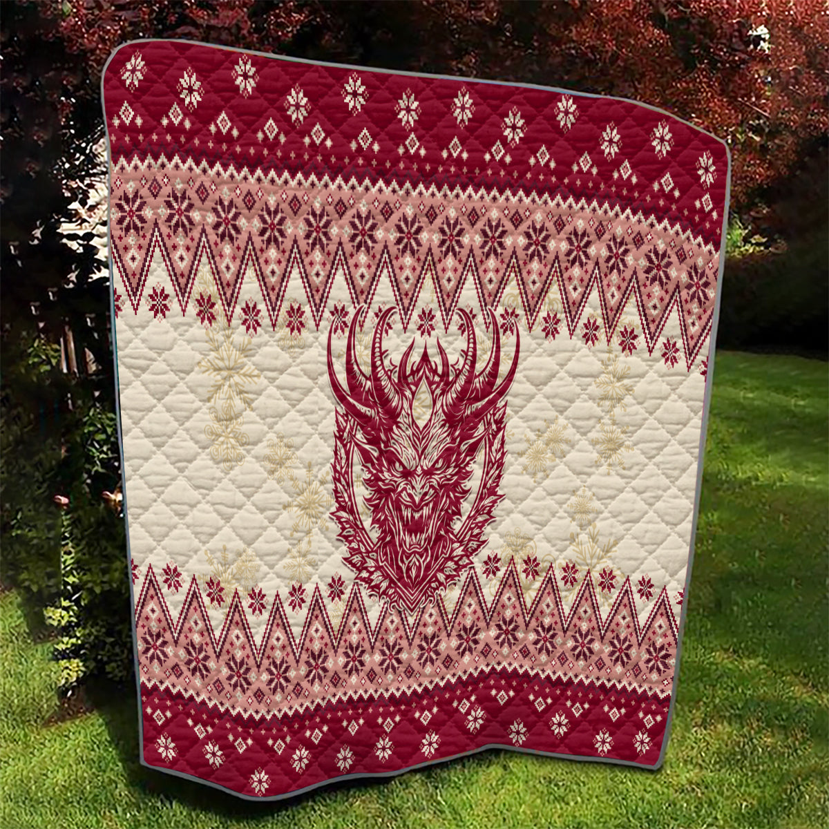 Red and cream quilt showing centered Krampus face over quilted diamond holiday pattern.