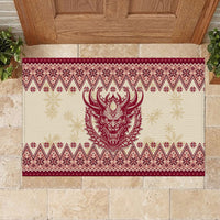 Red rubber doormat with Krampus face and repeating snowflake diamond pattern