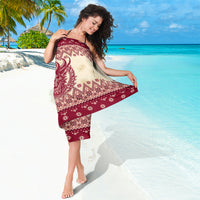 Cream and deep red sarong with horned Krampus graphic and repeating holiday pattern