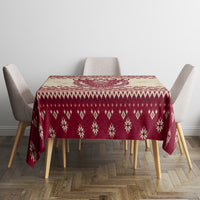 Red Christmas tablecloth with snowflake and diamond knit-style pattern around the edge
