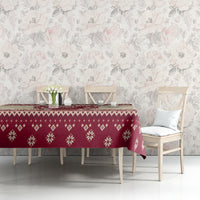 Red Christmas tablecloth with repeating snowflake and diamond pattern along table edge