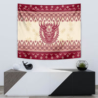 Christmas tapestry on wall with red-and-cream knit-style patterns and horned Krampus face