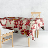 Red and white patterned Christmas tablecloth with plaid and small holiday characters