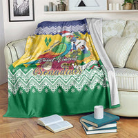 Christmas blanket with green, yellow, blue zigzag pattern and colorful parrot in Santa hat