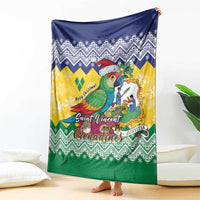 Draped Christmas blanket with blue, yellow and green chevrons; parrot graphic with Santa hat