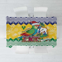 Christmas tablecloth with parrot graphic on yellow background and green blue zigzag trim