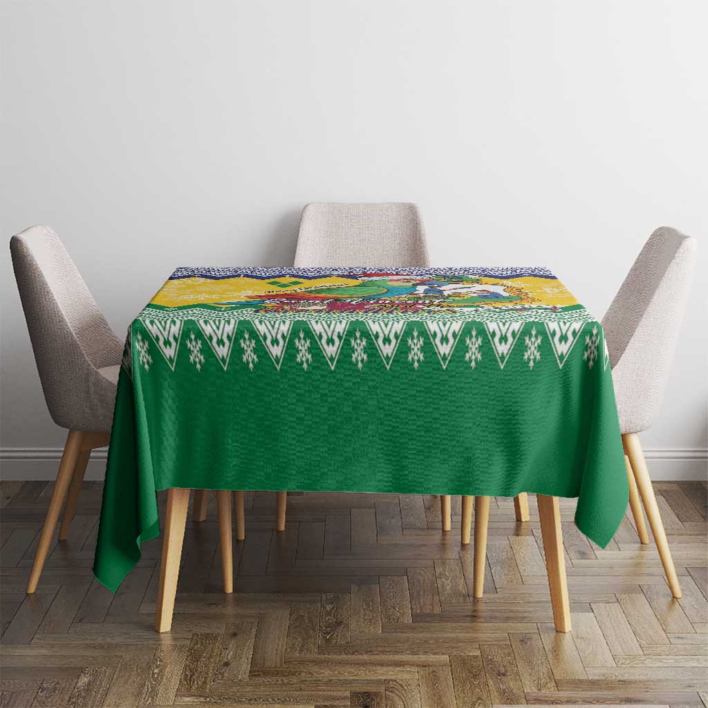 Green Christmas tablecloth with zigzag border and small patterned design over dining table