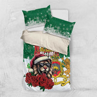 Green and white bedding set laid flat with Santa lion center panel and two pillowcases