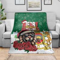 Morocco Christmas blanket on a sofa, green and white design with lion, roses, and crown