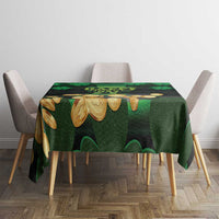 Green shamrock and gold motif tablecloth covering dining table
