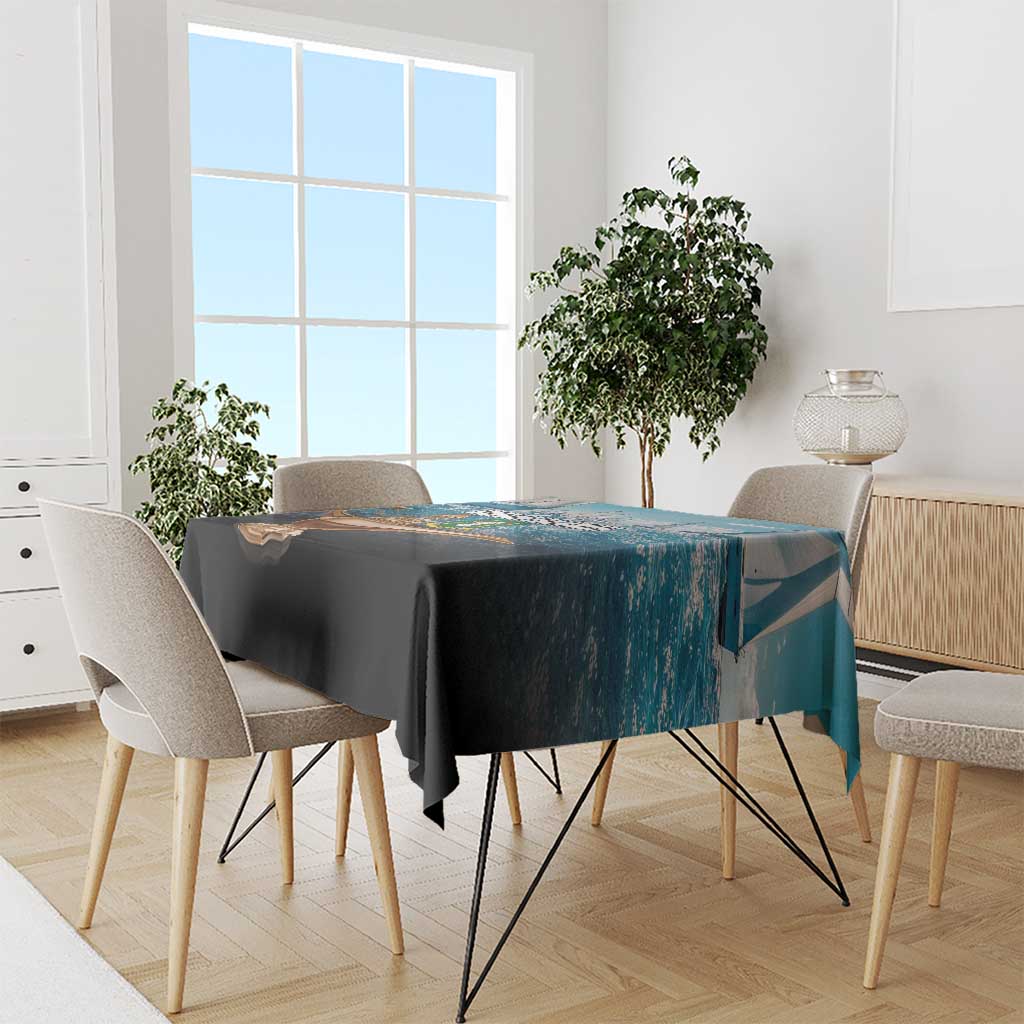 Nautical British Virgin Islands tablecloth in blue draped over dining table with chairs