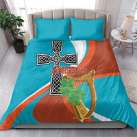 Bedding set with teal and rust duvet cover, cross and harp artwork, and two teal pillowcases