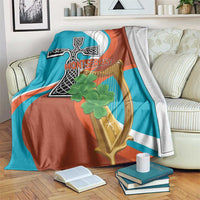 Teal and rust throw blanket with cross-harp emblem and clover graphic
