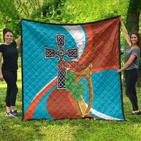 Quilted blanket spread out with Montserrat cross-and-harp flag graphic and green shamrocks