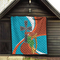 Quilted blanket displayed on wall with Montserrat cross-and-harp flag graphic and shamrocks