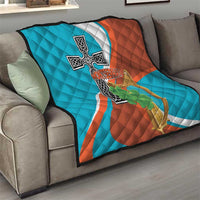 Quilted sofa throw with Montserrat flag cross and harp emblem and green shamrock motif