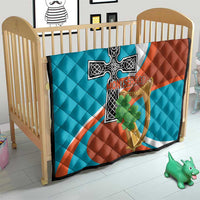 Quilted crib blanket with Montserrat flag cross-and-harp emblem and green shamrock graphic