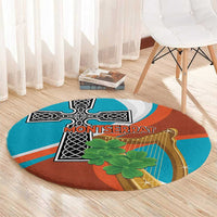 Round rug with teal and rust orange abstract harp-and-cross design, green leaves, curved border