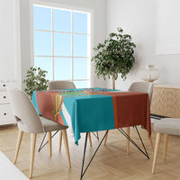 Rectangle teal and rust tablecloth with gold harp and black cross motif on dining table
