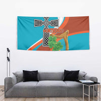 Wall tapestry showing Montserrat cross, gold harp, and green shamrock, teal and orange