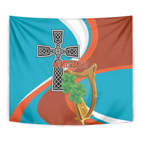 Wall tapestry close-up with Montserrat cross, gold harp, and green shamrock, teal and orange