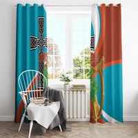 Teal and rust window curtains with black cross, gold harp, and green clover decoration.